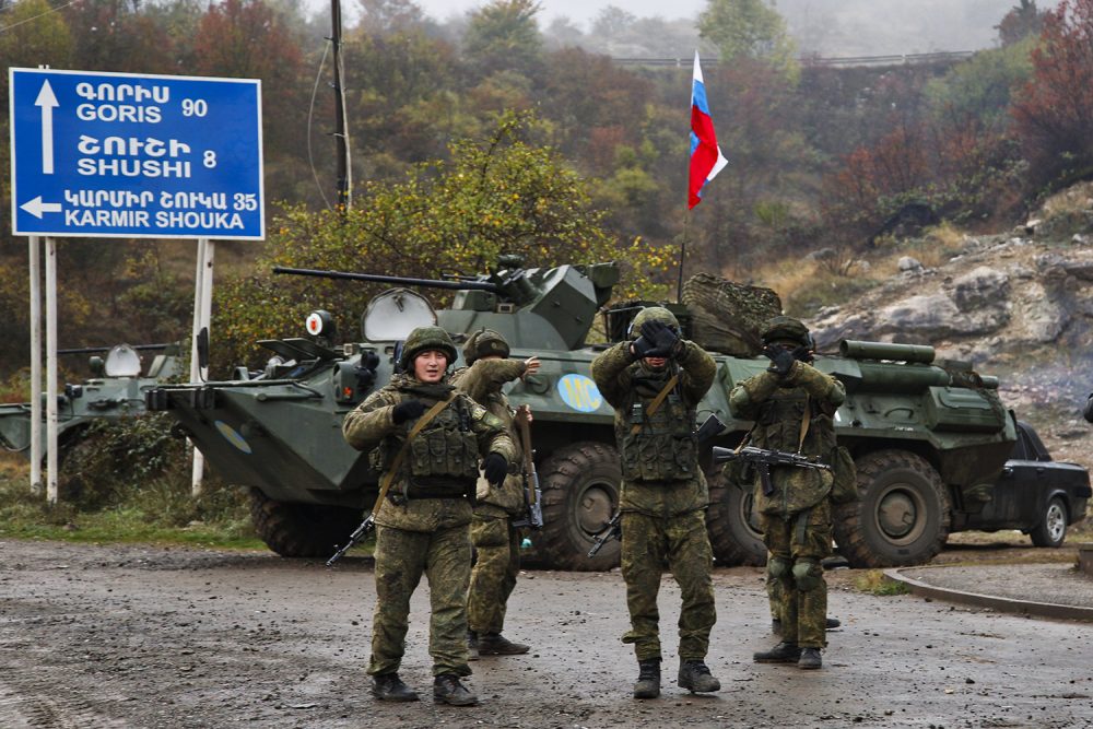 Russian peacekeepers hold up their hands to stop a photo being t