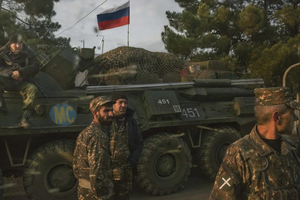 Armenian soldiers and a Russian peacekeeping soldier, on the vehicle, at a checkpoint in Nagorno-Karabakh, Nov. 17, 2020. (Mauricio Lima/The New York Times)