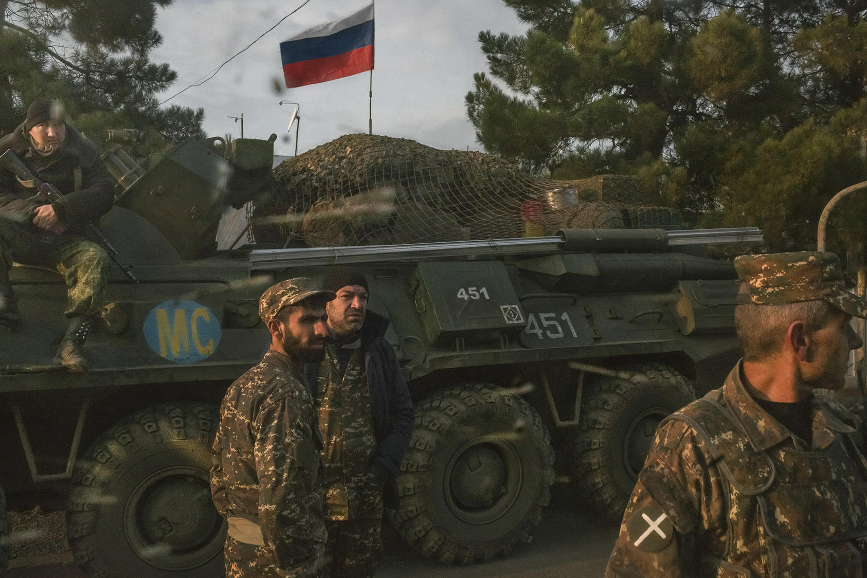 Armenian soldiers and a Russian peacekeeping soldier, on the vehicle, at a checkpoint in Nagorno Karabakh, Nov. 17, 2020. (Mauricio Lima/The New York Times)