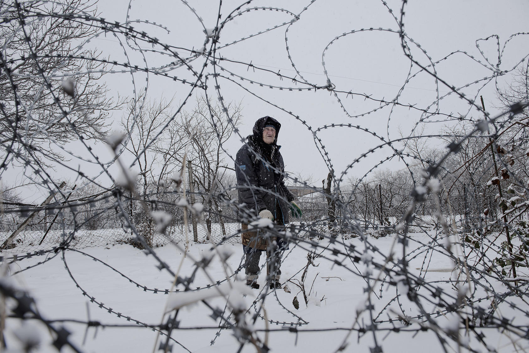 Valya Vanishvili, 85, whose home has been separated from the rest of the village by a Russian fence, in Khurvaleti, Georgia, on March 13, 2022. (Laetitia Vancon/The New York Times)