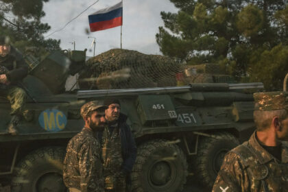 Armenian soldiers and a Russian peacekeeping soldier, on the vehicle, at a checkpoint in Nagorno Karabakh, Nov. 17, 2020. (Mauricio Lima/The New York Times)