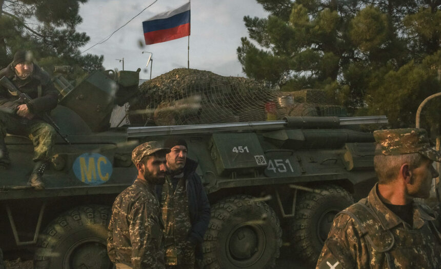Armenian soldiers and a Russian peacekeeping soldier, on the vehicle, at a checkpoint in Nagorno Karabakh, Nov. 17, 2020. (Mauricio Lima/The New York Times)