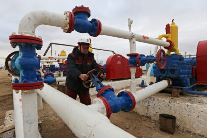 A worker checks the pressure of pumps at an oil pumping station in the Uzen oil and gas field in the Mangistau Region