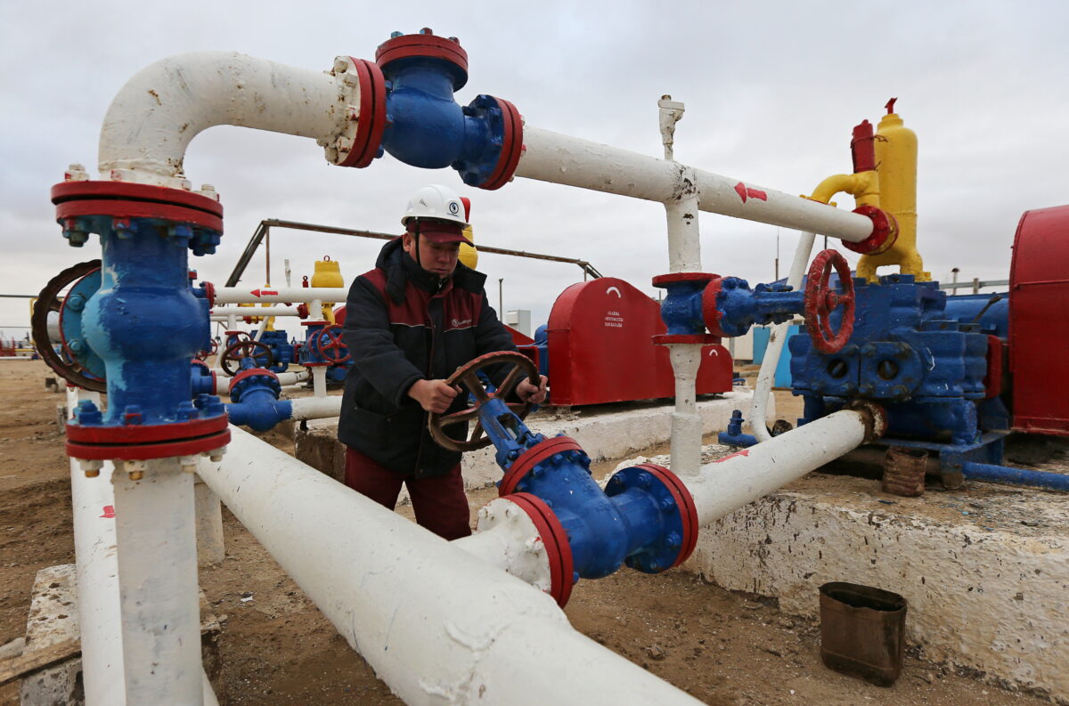 A worker checks the pressure of pumps at an oil pumping station in the Uzen oil and gas field in the Mangistau Region